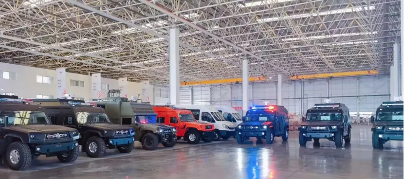 A row of tactical and emergency patrol vehicles parked inside a large factory