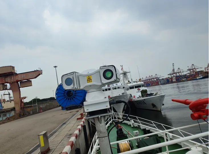 Dual-lens marine PTZ camera mounted on a ship at a port