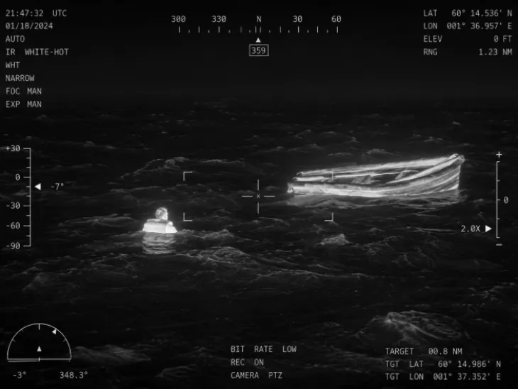 Thermal camera view of a person and boat overboard
